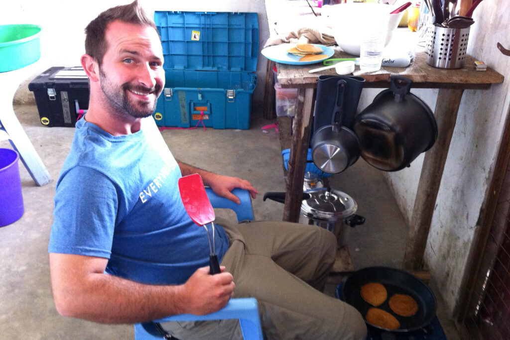 Missionary cooking pancakes on kerosene stove in Nasir, South Sudan.